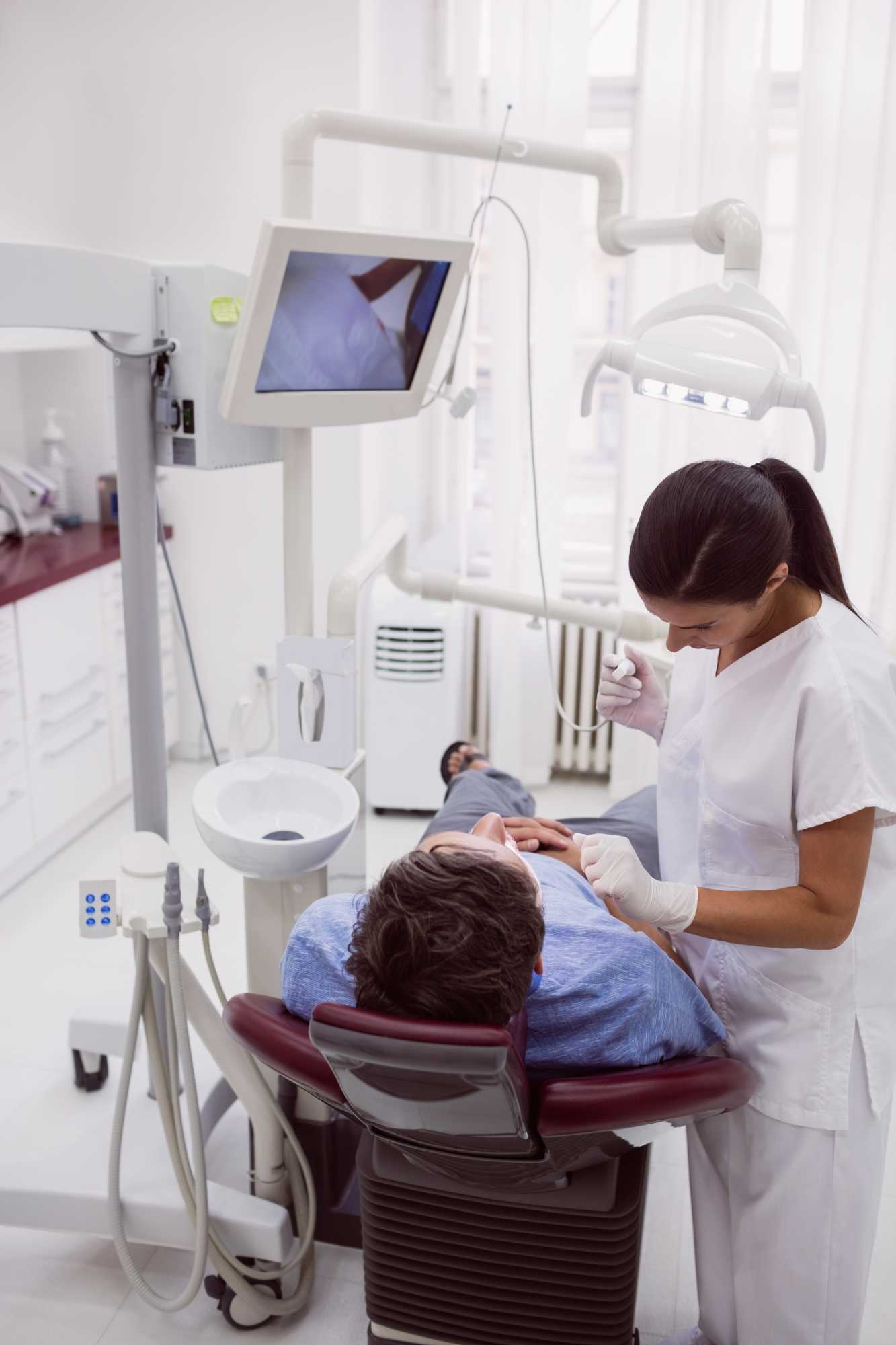 female-dentist-examining-patient (1)